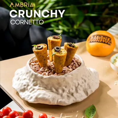 My Crunchy Cornetto, a bite-sized appetizer filled with a savoury mixture and topped with an olive. It's a perfect example of creative, fusion finger food.