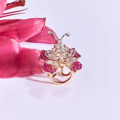 Presenting the Exotic Butterfly Ring, a mesmerizing fusion of artistry and innovation. Set in fiery rubies and scintillating diamonds, this one-of-a-kind masterpiece flutters with movement, capturing the beauty of a butterfly in flight.
