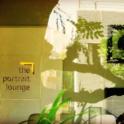 For 'the portrait lounge' retail store, we used reflections and natural elements to create an intriguing entrance. The design plays with light and shadow, inviting curiosity and drawing customers inside.