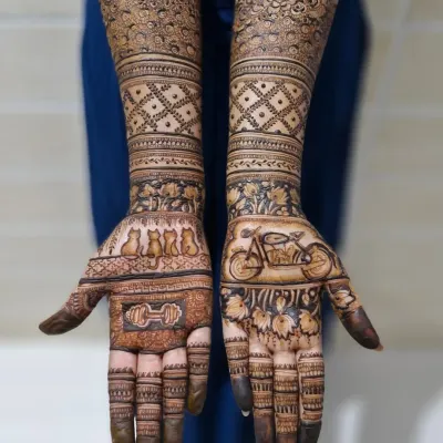 A full view of the custom bridal mehendi, showing how the personal elements on the palms transition into traditional patterns on the arms.