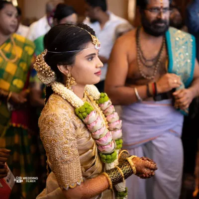 A candid shot of the bride during her wedding ceremony. The makeup looks flawless even in motion, ensuring she looks perfect from every angle throughout the rituals.