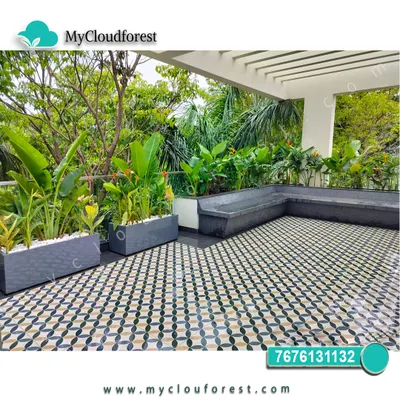This terrace features a built-in L-shaped bench and modern planters filled with tropical foliage. The patterned tile floor adds a decorative touch, creating a stylish and comfortable outdoor lounge area.