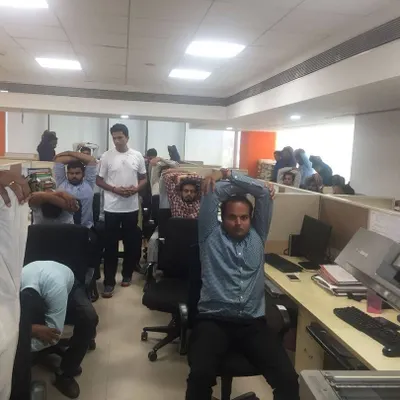 I offer on-site corporate yoga workshops and regular classes tailored to the office environment. In this session, employees are learning simple stretches they can do at their workstations to alleviate neck and shoulder tension caused by prolonged computer use.