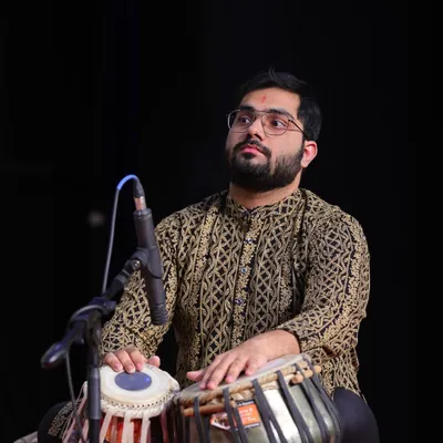 A moment of deep concentration during a live tabla performance. When I play, it feels like speaking a language without words, a sentiment beautifully expressed by the great Anindo Chatterjee.