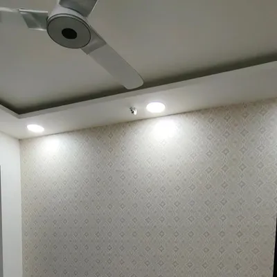 A simple, small-patterned wallpaper that adds subtle texture and elegance to a room.