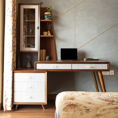 A gorgeous work desk can make Monday mornings a little brighter. This study area from our Neelabh project combines a sleek, mid-century modern desk with an attached storage unit, offering ample space to stay organized and productive.