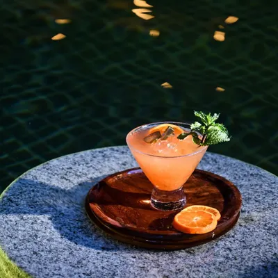 Our 'garden-to-glass' philosophy comes to life in this refreshing orange and mint cocktail, served by the pool. Each sip is a taste of the fresh, seasonal ingredients grown right here at our resort.