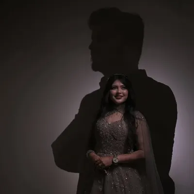 In her smile, he lives. A conceptual couple portrait using the groom's shadow to frame the bride, symbolizing his love lighting up her world.