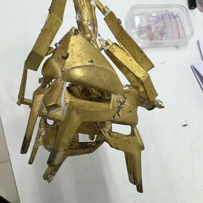 A behind-the-scenes look at the casting process. This is a raw brass mold, the first physical form of a custom grillz design before it's cast in precious metal and polished. This is where the idea starts to become real.