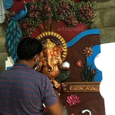 An artist from our team is seen here carefully painting a large Ganesha mural. This hands-on approach allows us to control every detail, from the sculpting of the form to the final stroke of the brush, delivering a truly custom piece of art.