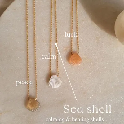 My sea shell pendants, each carved from a different stone to offer a unique energy. I use howlite for calm, peach moonstone for luck, and mother of pearl for peace.