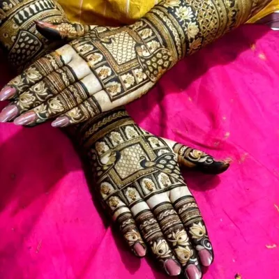 This engagement mehndi is for the bride who loves both peacocks and traditional Indian designs. The detailed grid work and bold motifs create a truly stunning look.