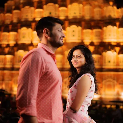 A stunning night portrait with the illuminated Hawa Mahal creating a grand, royal backdrop. This shot from a Jaipur pre-wedding session highlights our expertise in using iconic locations to create breathtaking images.