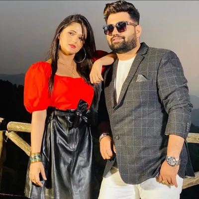 A still from the Haryanvi romantic song 'Pyaar Ke Parindey'. I styled Anjali Raghav in a bold red top and a faux leather skirt with a bow detail, creating a modern and chic look for her.
