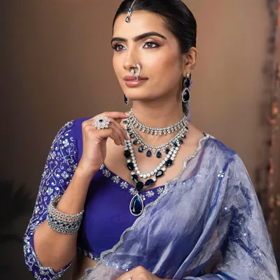 A modern and minimalist look perfect for a reception. I created a glowing, lit-from-within skin finish and paired it with a graphic blue and silver eye to complement the stunning saree.