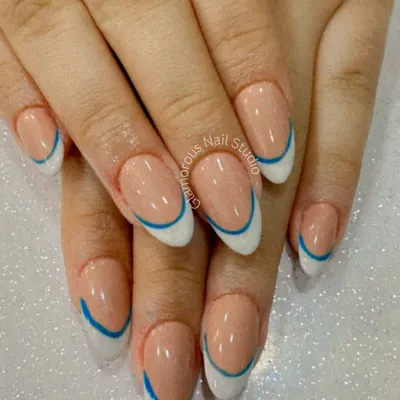We believe even classics can have a modern twist. Here, we've updated the timeless French manicure with a clean white tip and a sharp, electric blue line for a look that is chic, clean, and totally unique. It's a perfect example of minimalist design with maximum impact.