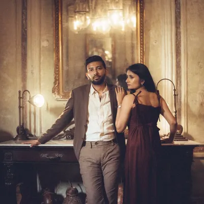 A powerful and stylish portrait of a couple in a vintage setting in Pondicherry. The classic decor and dramatic lighting create a cinematic and timeless feel.
