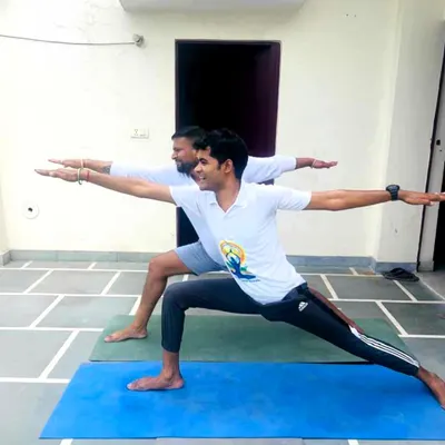 Guiding a client through Virabhadrasana II (Warrior II pose) during a personal training session. I focus on correct alignment and posture to ensure you get the maximum benefit from each asana.