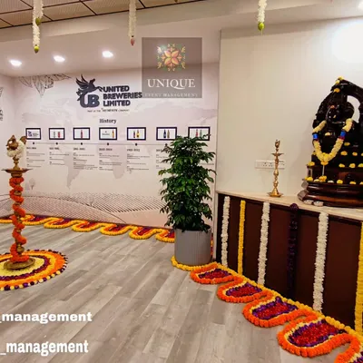 We designed this traditional and elegant setup for the office inauguration of United Breweries Limited. The decor features auspicious marigold flower arrangements, intricate floral floor patterns, and classic brass lamps to create a welcoming atmosphere for the opening ceremony.