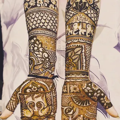 A beautiful example of full-arm bridal mehndi rich with classic motifs. The design features majestic elephants, graceful swans, lotus flowers, and intricate jaal (net) patterns for a timeless look.