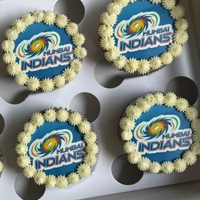 Cheer on your favorite team with these custom logo cupcakes. This box of four was made for a Mumbai Indians fan, featuring the team's logo printed on edible paper and placed on a chocolate cupcake with a border of vanilla buttercream.