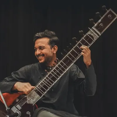 The delightful experience of performing alongside the esteemed Pt. Ram Kumar Mishra Ji. This photo captures the joy and connection that happens on stage during a live classical concert.