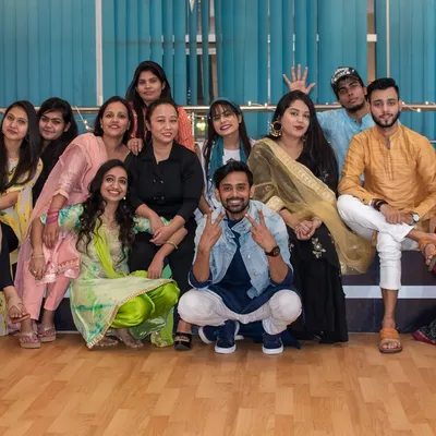 More than just a dance class, we are a family. This is our crew during a studio celebration, all dressed up and enjoying the festive vibe. I create this same sense of community and fun for your sangeet group, making rehearsals a memorable part of your wedding.