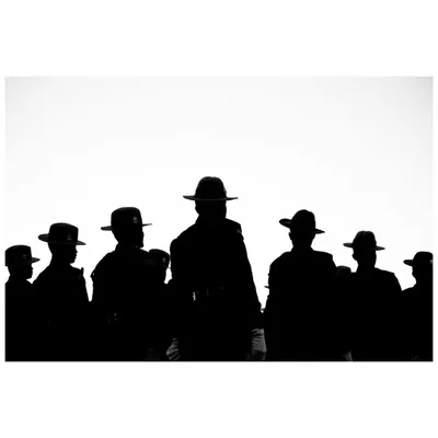 A powerful silhouette of soldiers against a stark white sky during Republic Day rehearsals. The anonymity emphasizes their collective identity.