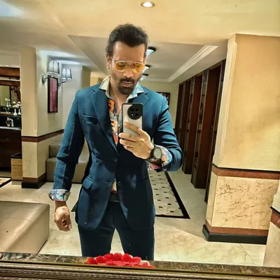 A quick selfie before a gig. I'm wearing a stylish blazer over a floral shirt, a look that's perfect for an upscale cocktail party.
