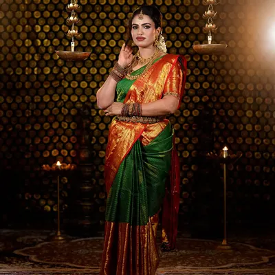 A full-length portrait from my Varamahalakshmi festival photoshoot. I styled myself in a traditional green and red silk saree with temple jewellery, creating a makeup look that was both festive and elegant.