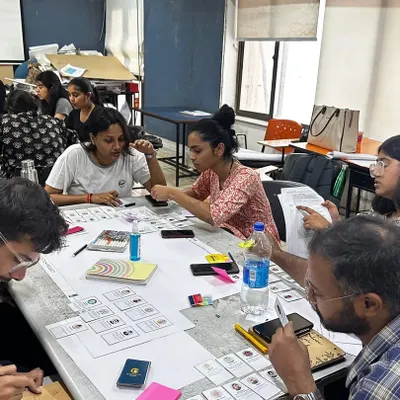A wide shot of our workshop on urban policy for Masters of Urban Design students at SPA New Delhi. The room is buzzing with energy as multiple groups engage in a gamified exercise to understand urban regeneration.
