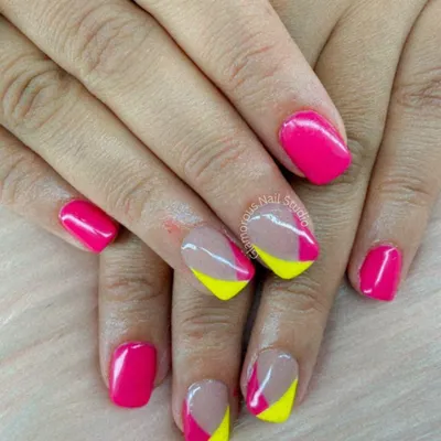 A fun and modern color-block design. We used a vibrant hot pink and a cheerful neon yellow to create this playful look on short, square-shaped nails.