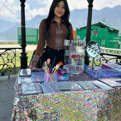My setup for a beautiful outdoor event. Having a professional and inviting table with all your paints, brushes, and glitter organized is key to attracting clients.