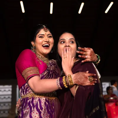 A moment of pure, uninhibited laughter and surprise between two friends at an engagement party. It's these candid shots that tell the real story.