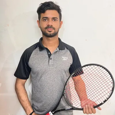 This is our Head Coach, Rahul. With his experience and strategic coaching, he has been instrumental in molding our players into top-ranked competitors. His passion for the game inspires everyone at the academy.