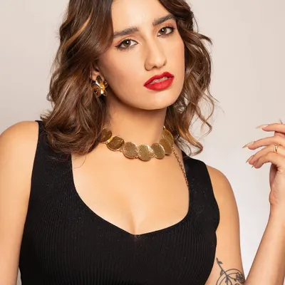 The essence of modern glamour. This close-up showcases a classic bold red lip, soft waves, and clean, radiant skin, a look that is both timeless and effortlessly confident.