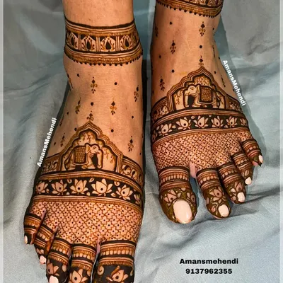 Beautiful bridal feet henna. This design features traditional motifs like elephants and palaces, with intricate patterns covering the toes and extending up the foot.