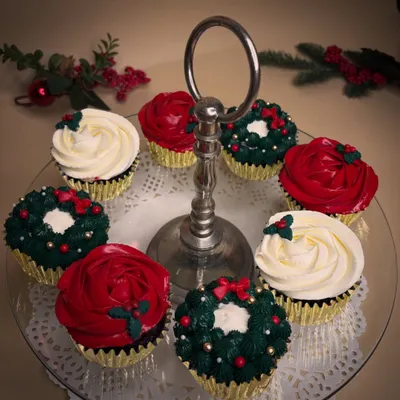 Christmas in a cupcake. This festive assortment includes classic chocolate and vanilla cupcakes decorated with vanilla bean frosting to look like wreaths, roses, and holly.