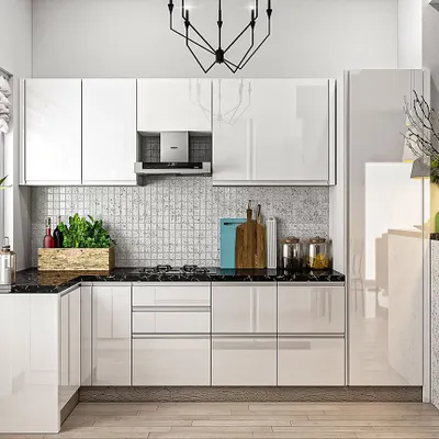 This compact L-shaped kitchen feels bright and spacious thanks to its high-gloss white handleless cabinets. The reflective surface bounces light around the room, while the black marble countertop and mosaic backsplash add a touch of classic elegance.