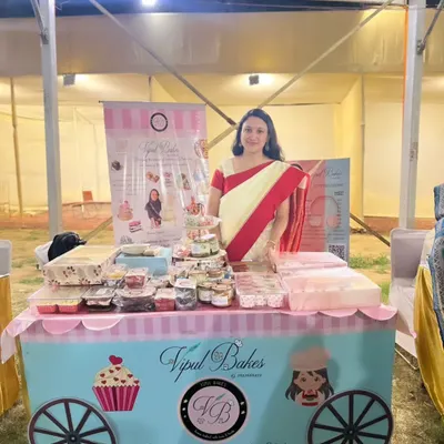 Here I am at my stall during a Durgostav and Dandiya pop-up. My little cart is filled with cupcakes, dessert jars, and other festive treats.