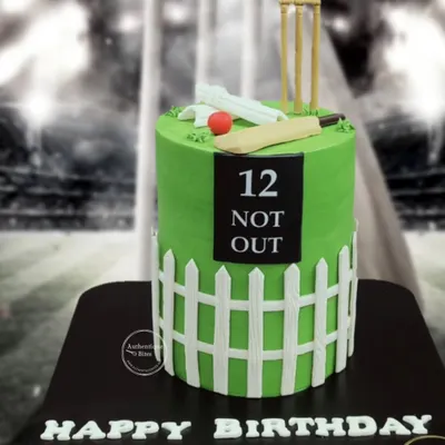 A fantastic cricket-themed cake for a 12th birthday. This cake looks like a cricket pitch with a picket fence, complete with a bat, ball, and wickets on top.