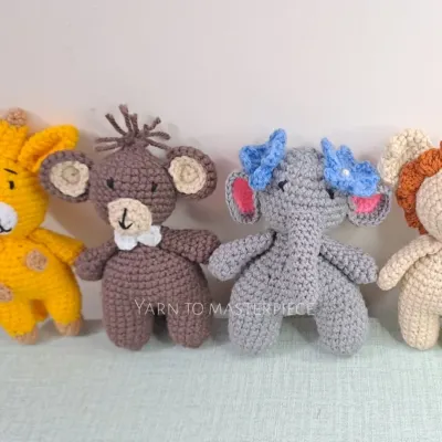 These are the individual characters for my jungle-themed cradle mobile. The set includes a giraffe, monkey, elephant, and lion, each with a rattle inside.