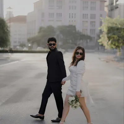 A confident stride across an empty city street. This image captures the essence of a modern love story: stylish, bold, and in step with one another. The architecture provides a clean, powerful backdrop for their connection.