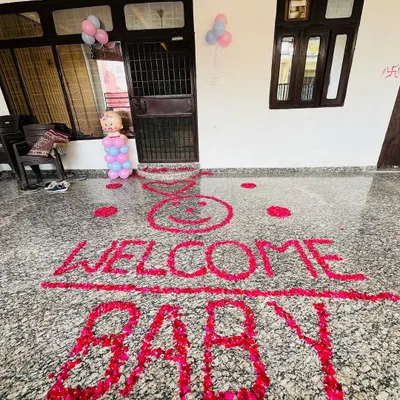 A simple and heartfelt welcome message created with red rose petals on the floor. This "WELCOME BABY" floor art is a beautiful way to greet the newborn at the entrance of your home.