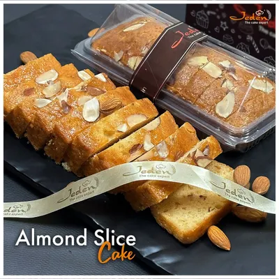 Our Almond Slice Cake is a timeless classic. This moist and buttery cake is generously topped with sliced almonds, offering a delightful crunch and nutty flavor in every bite. It's perfect for any time of day.