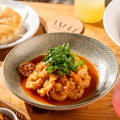 A bowl of delicious garlic prawns from Azule, Goa. The bright, natural light gives it a fresh, beach-side feel.