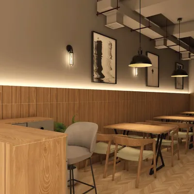 The lighting and material choices in a cafe are essential for setting the mood. Here, I combined warm wood paneling with soft, layered lighting from wall sconces and strip lights to create a welcoming and dynamic atmosphere for patrons.