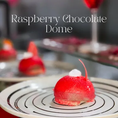 This is my Raspberry Chocolate Dome, a dessert that's as beautiful as it is delicious. It features a soft sponge base, a rich Nutella chocolate mousse center, and a vibrant raspberry coating for a perfect balance of flavours.