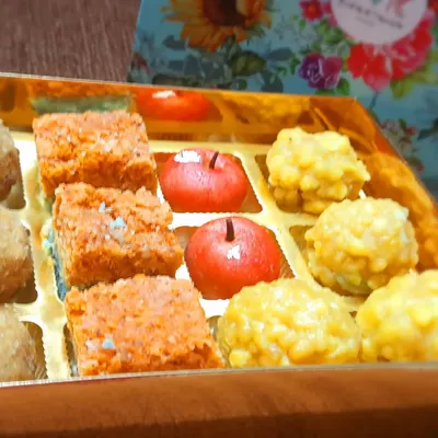 An assorted Diwali sweet box, perfect for gifting. This box features a mix of my bestsellers like Coconut Burfi, Kaju Apples, and Boondi Ladoos, all packed beautifully to share with your loved ones.