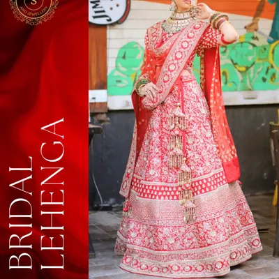 A classic red bridal lehenga with intricate all-over embroidery. This is a timeless choice for the main wedding ceremony, giving you that quintessential Indian bride look.